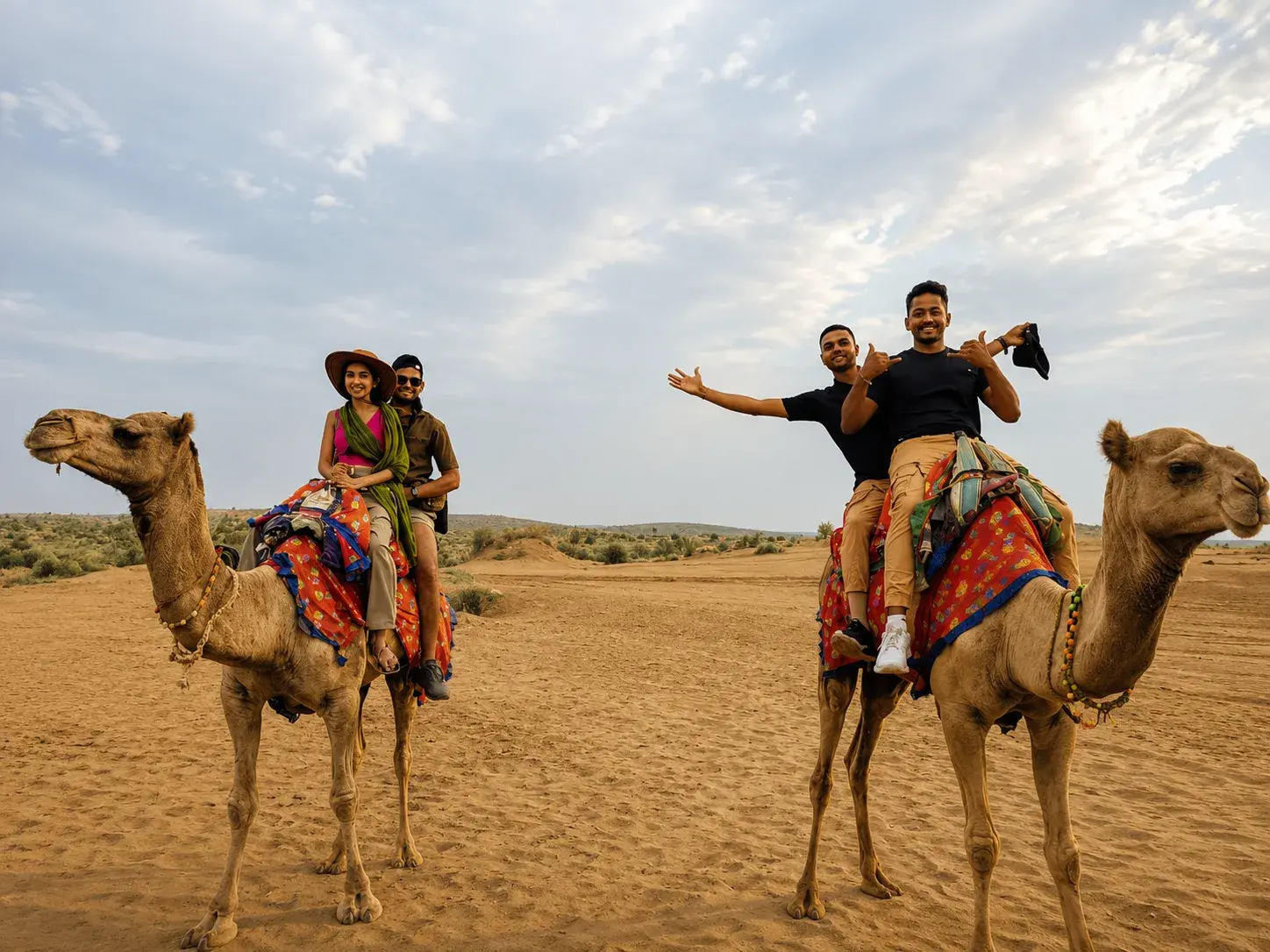 Travelers on a camel safari in the Jaisalmer desert