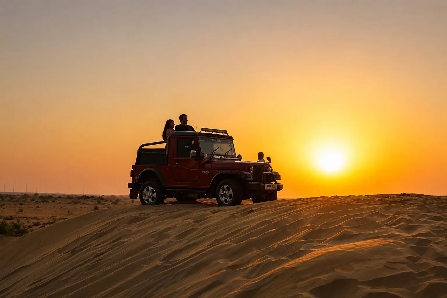 Off-road vehicle crossing desert dunes, representing Jaisalmer taxi and transfer routes